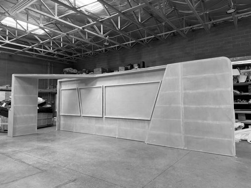 Long curved display wall with framed product windows