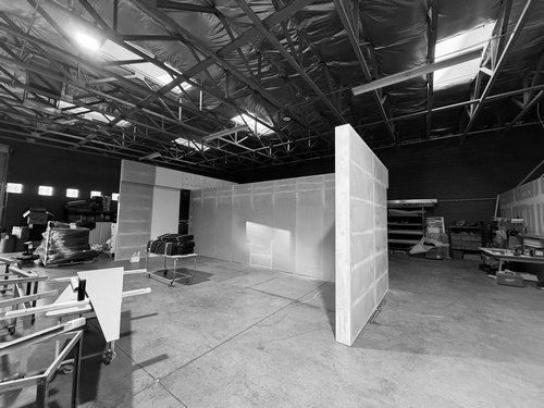 White exhibit partitions staged during workshop pre-build