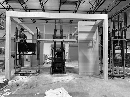 Crew assembling a large exhibit portal and back wall