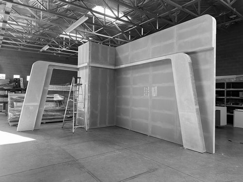 Corner exhibit structure with angled lightbox frames