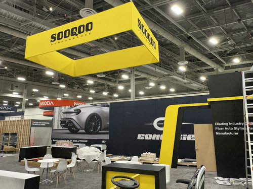 Yellow overhead exhibit identifier designed for long-distance visibility on the show floor