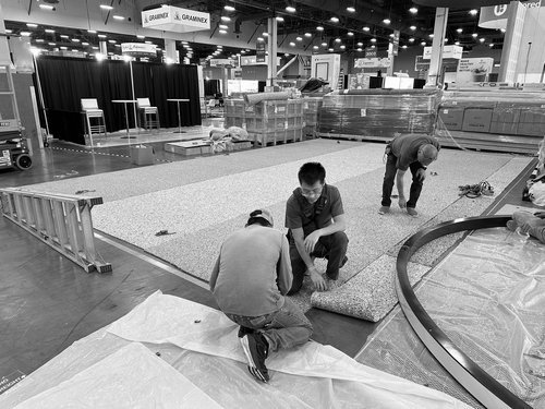 Install crew fitting graphics to the H&M USA hanging sign