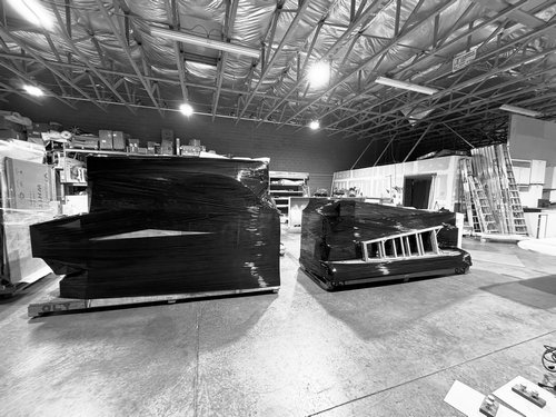 Protected exhibit components staged in the workshop for shipping