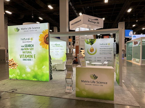 Printed exhibit graphics integrated across a branded show-floor booth
