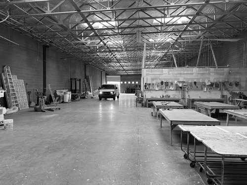Las Vegas exhibit workshop with production tables and panels