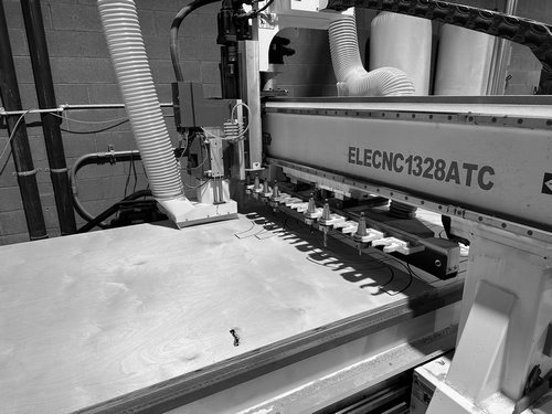 CNC router cutting a wood exhibit panel