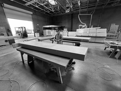 Long exhibit panels staged on production tables