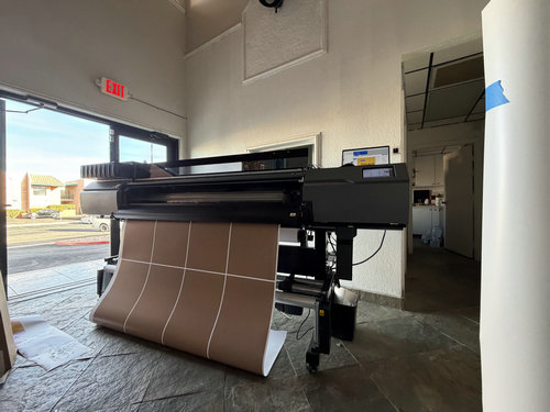 Large-format graphics being produced on a wide-format printer in the Innovexhibit workshop