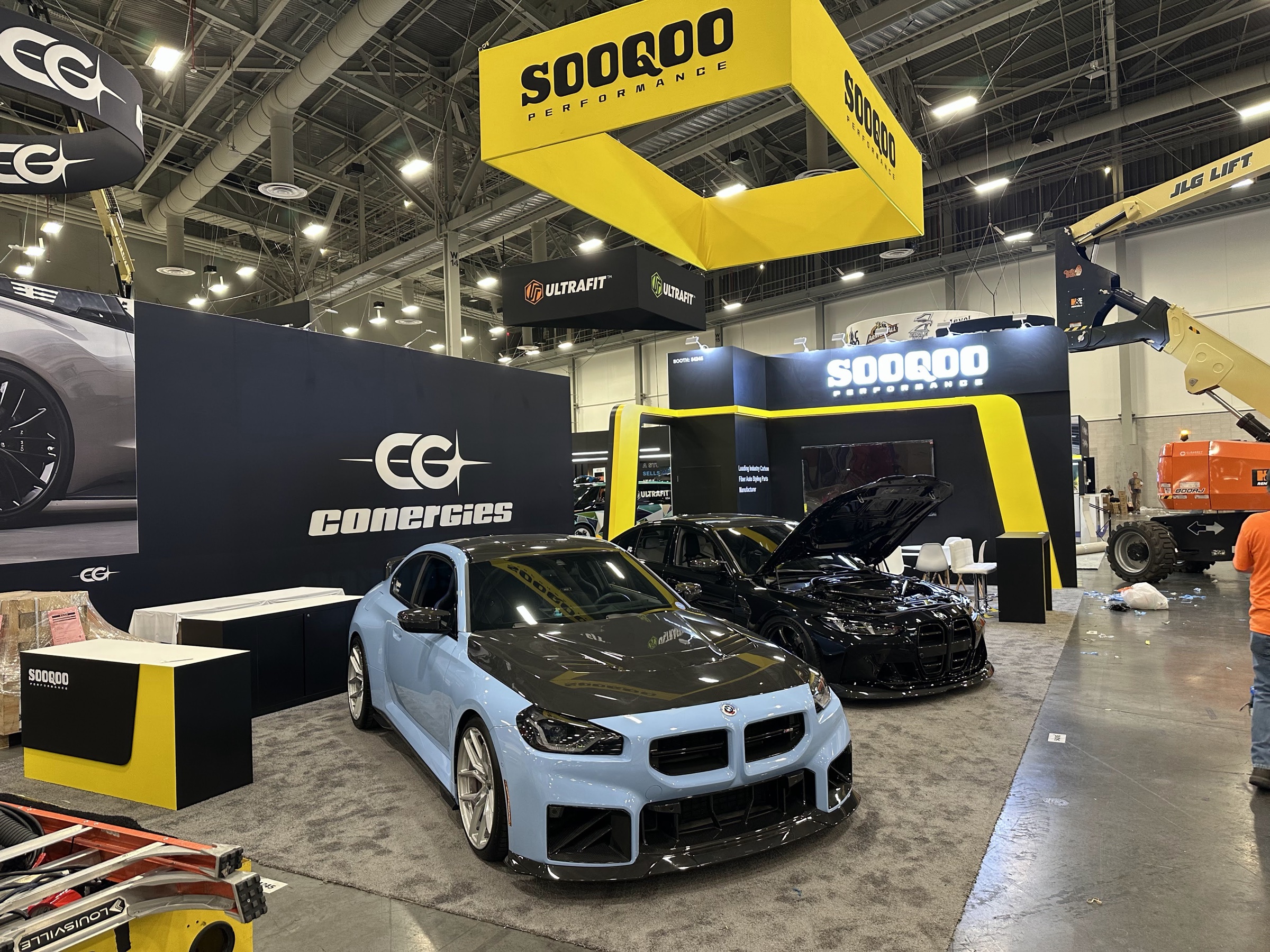 SOOROO and Ultrafit vehicle exhibit with overhead signs at SEMA in Las Vegas